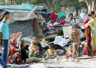 A group of people sitting around in the dirt.