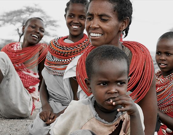 A group of people with red necklaces and one child