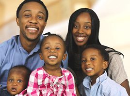 A family of six posing for the camera.