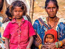 A woman and two children standing next to each other.