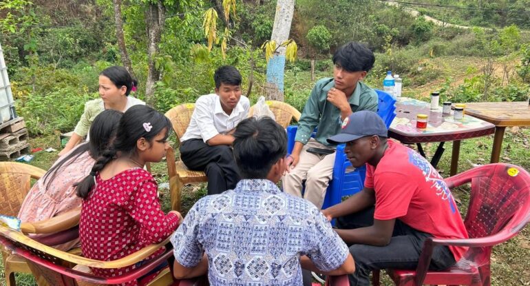 A group of people sitting around a table.